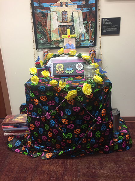 Photo of a colorful altar erected in Luis Leon’s honor in the Department of Religious Studies at the University of Denver